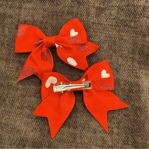 Red ribbon with red glitter and white pigtail bows
